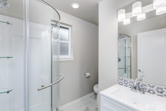 bathroom with vanity, toilet, and a shower with shower door