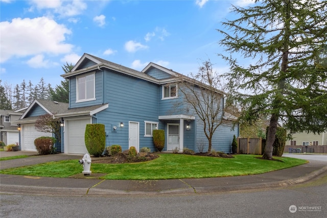 view of front property featuring a garage and a front yard