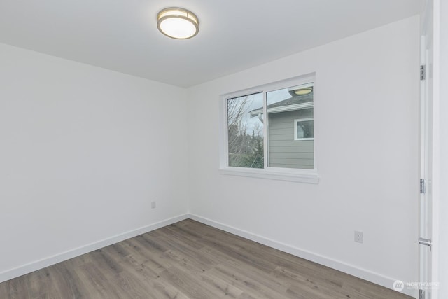 empty room with hardwood / wood-style flooring