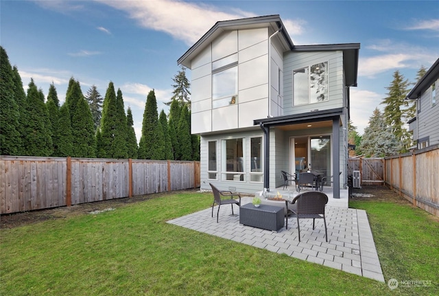 rear view of property with a patio area, an outdoor hangout area, and a yard