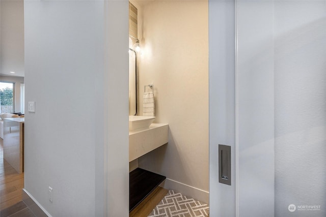 bathroom with hardwood / wood-style floors