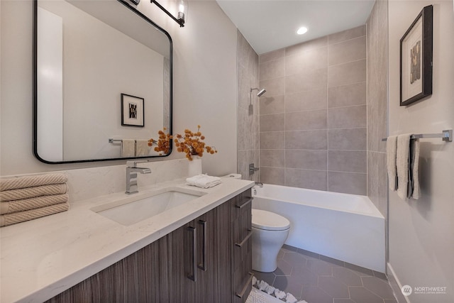 full bathroom featuring toilet, vanity, tile patterned floors, and tiled shower / bath