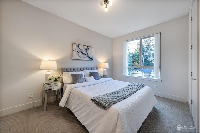 bedroom with carpet flooring and lofted ceiling