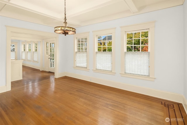 empty room featuring beam ceiling and wood-type flooring