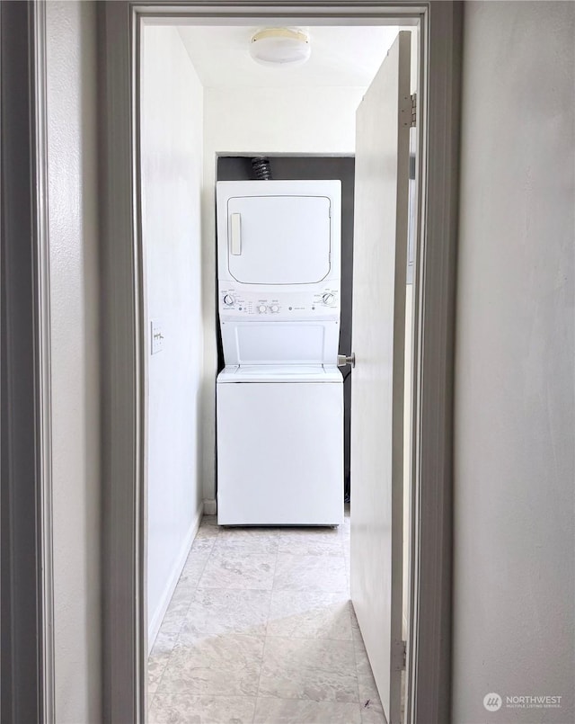 washroom featuring stacked washer and clothes dryer