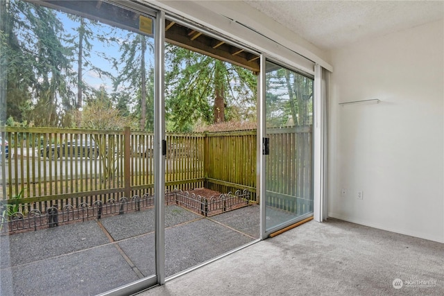 entryway with a textured ceiling and carpet floors