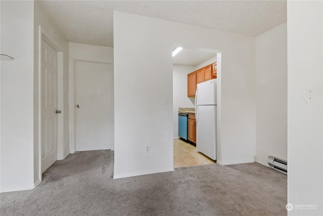 carpeted empty room featuring a textured ceiling and a baseboard radiator