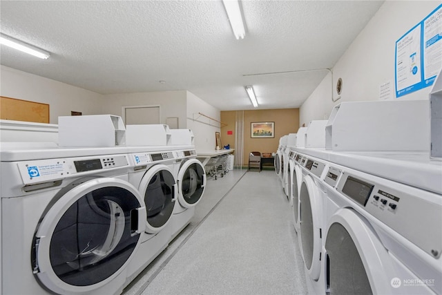 laundry room with washer and dryer and a textured ceiling