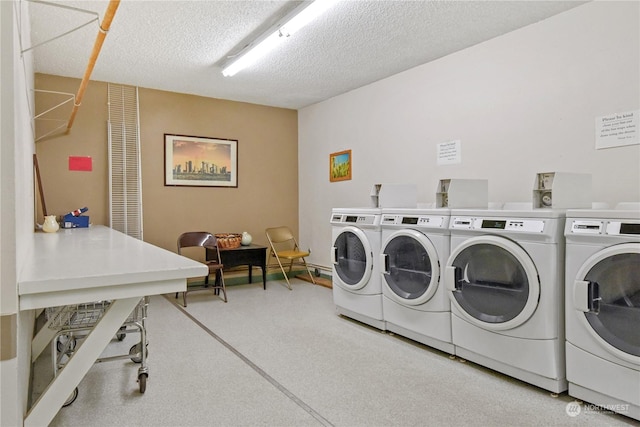 washroom with separate washer and dryer and a textured ceiling