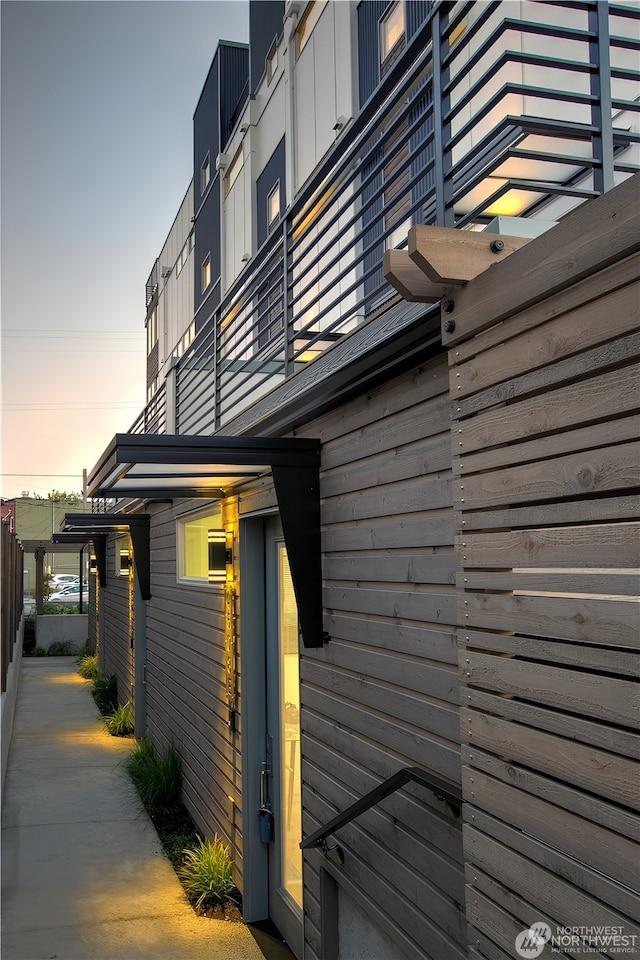 property exterior at dusk with a balcony