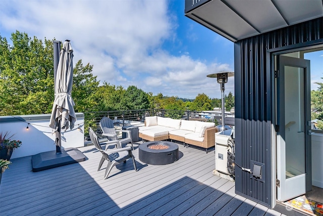 deck with an outdoor living space with a fire pit