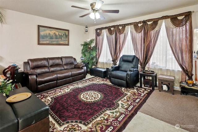 carpeted living room with ceiling fan