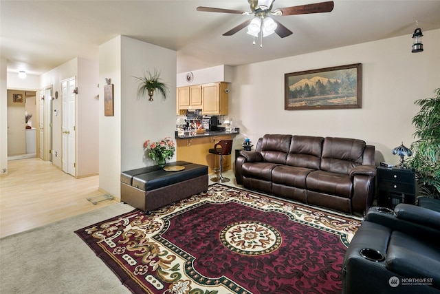 carpeted living room featuring ceiling fan