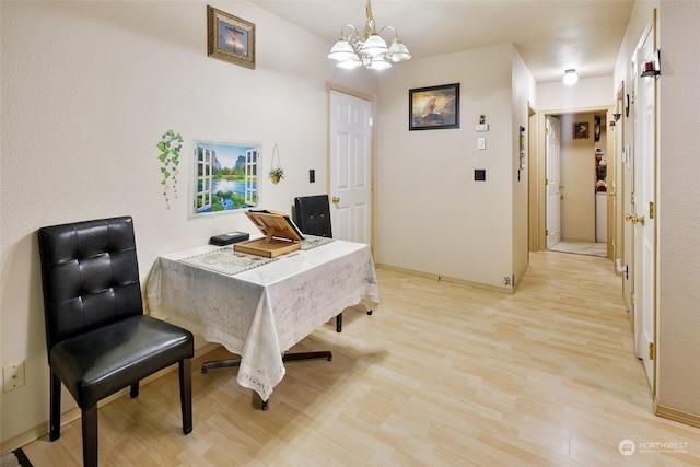 dining area featuring a notable chandelier and light hardwood / wood-style flooring