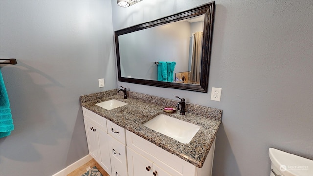 bathroom featuring vanity and toilet