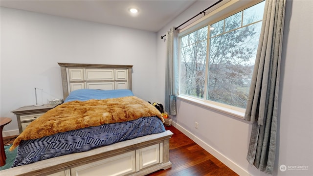 bedroom with dark hardwood / wood-style floors