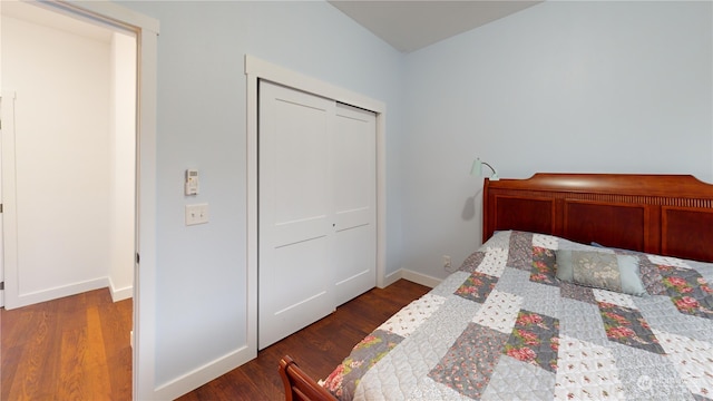 bedroom featuring dark hardwood / wood-style floors and a closet