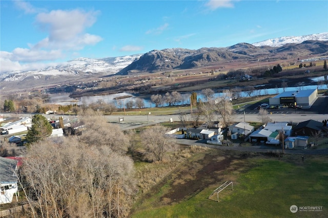 birds eye view of property with a water and mountain view