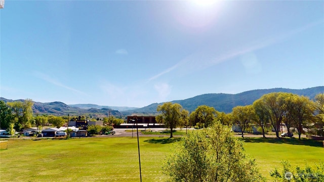 view of community with a lawn and a mountain view
