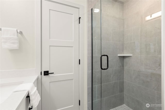 bathroom with vanity and a shower with door