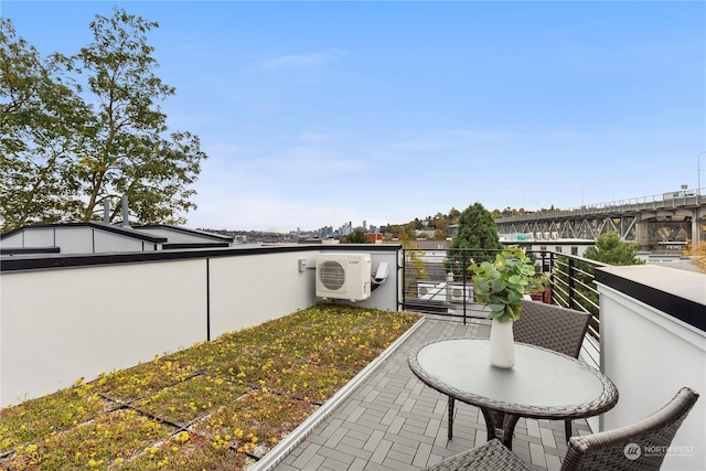 view of patio / terrace featuring ac unit and a balcony