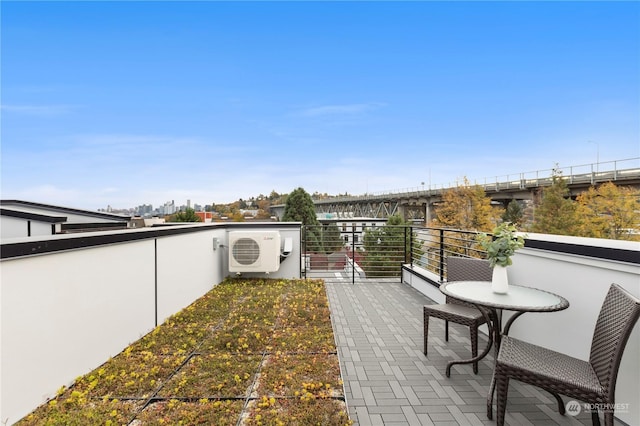 view of patio / terrace with a balcony and ac unit