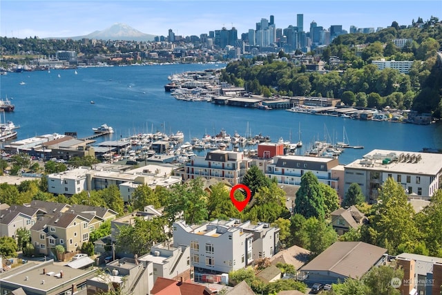 birds eye view of property with a city view and a water view