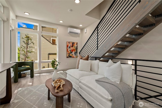 922B N 35th St, Seattle, WA 98103 - living area with a wall unit AC, wood finished floors, recessed lighting, and stairs