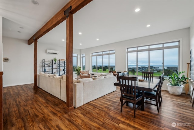 living room with an AC wall unit, a wealth of natural light, dark hardwood / wood-style flooring, and beamed ceiling