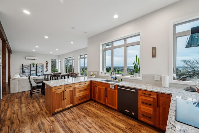 kitchen featuring black appliances, kitchen peninsula, dark wood-type flooring, and sink