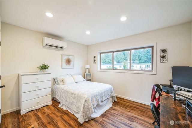 bedroom with hardwood / wood-style flooring and an AC wall unit