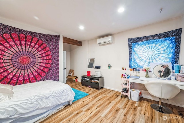 bedroom featuring light hardwood / wood-style flooring and a wall mounted air conditioner