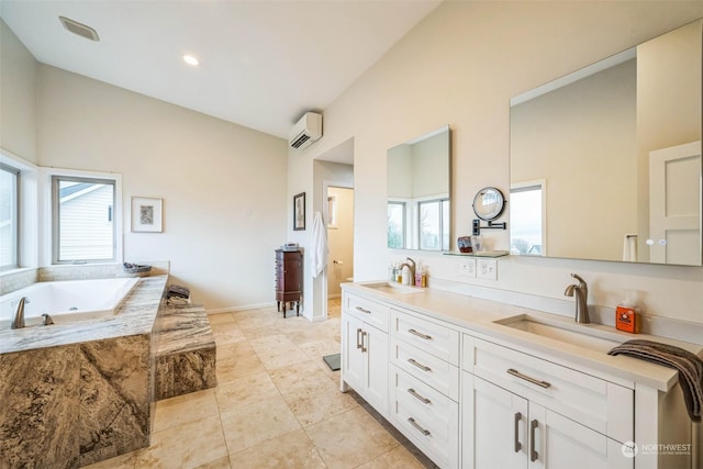 bathroom with a wall unit AC, a wealth of natural light, a relaxing tiled tub, and vanity