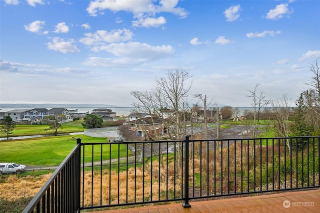 wooden deck featuring a water view and a yard