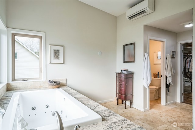 bathroom featuring tiled bath and a wall unit AC