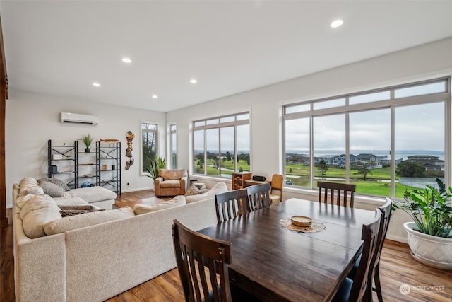 dining room with hardwood / wood-style floors and a wall mounted air conditioner