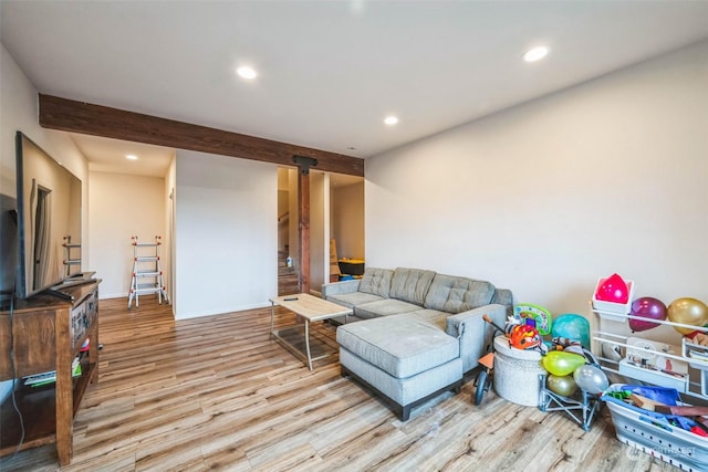 living room with beamed ceiling and light hardwood / wood-style floors