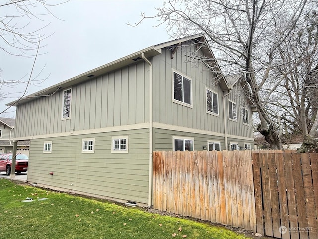 view of side of home featuring a lawn