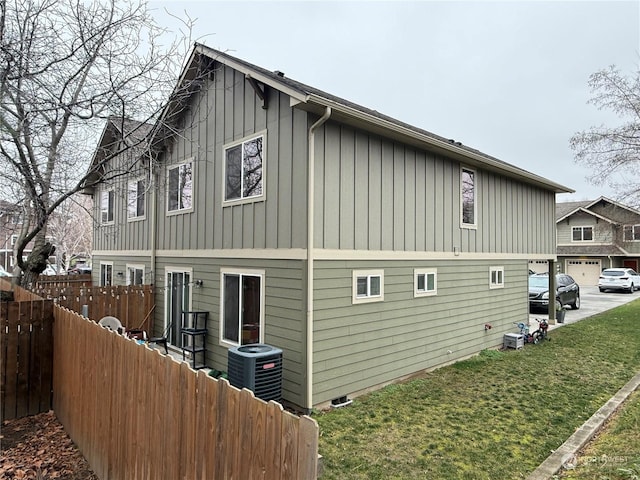 view of home's exterior with a lawn and cooling unit