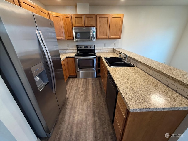 kitchen featuring stainless steel appliances, dark wood-type flooring, and sink