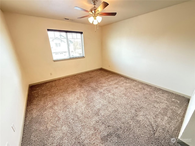 carpeted spare room featuring ceiling fan