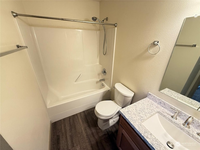 full bathroom featuring shower / washtub combination, vanity, wood-type flooring, and toilet