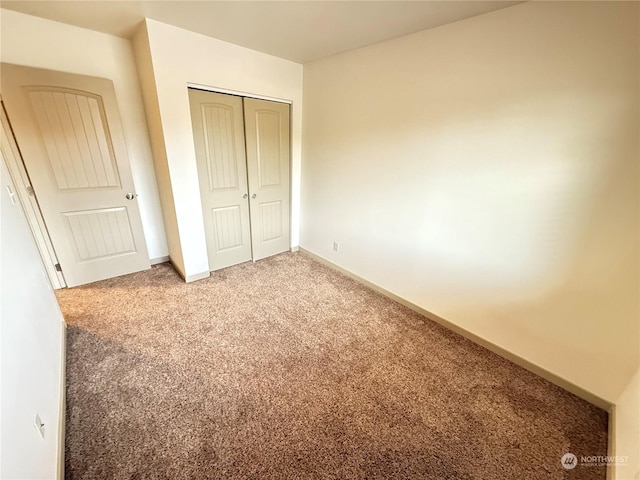 unfurnished bedroom with carpet and a closet