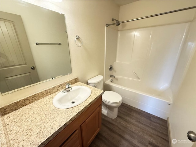 full bathroom featuring bathing tub / shower combination, vanity, wood-type flooring, and toilet