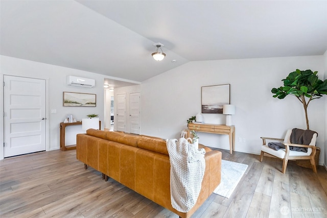 living room featuring a wall mounted AC, vaulted ceiling, and light wood-style flooring