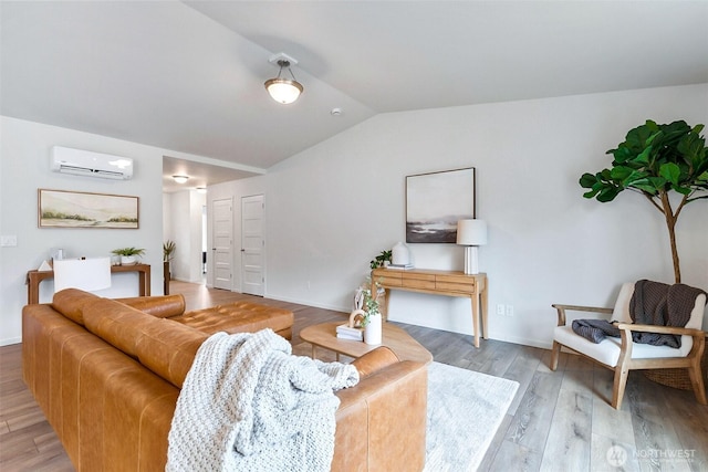 living room featuring light wood finished floors, a wall mounted air conditioner, and vaulted ceiling