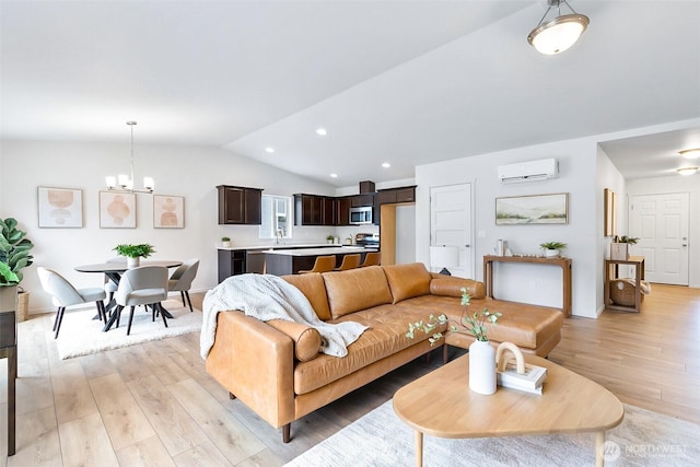 living area with recessed lighting, an inviting chandelier, an AC wall unit, light wood-style floors, and vaulted ceiling