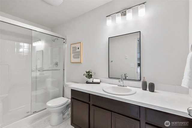 full bath with vanity, toilet, and a stall shower