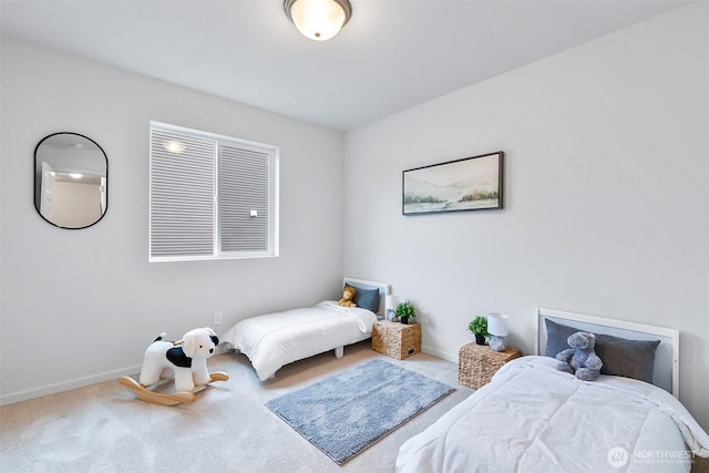 bedroom with carpet floors and baseboards