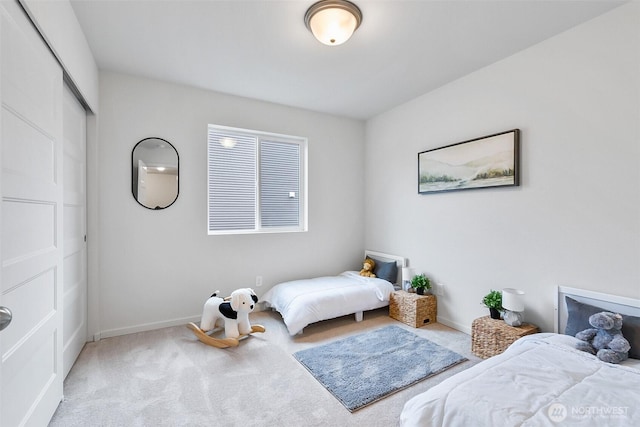 bedroom featuring baseboards, a closet, and carpet floors